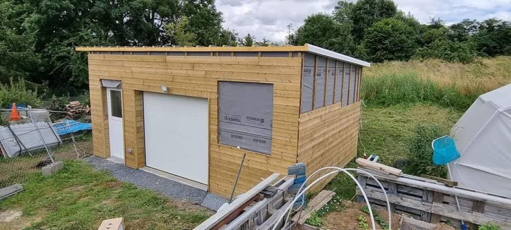 Ossature bois en Normandie : construction d’un abri/garage en bois, structure montée et bardage en cours – AJL HABITAT